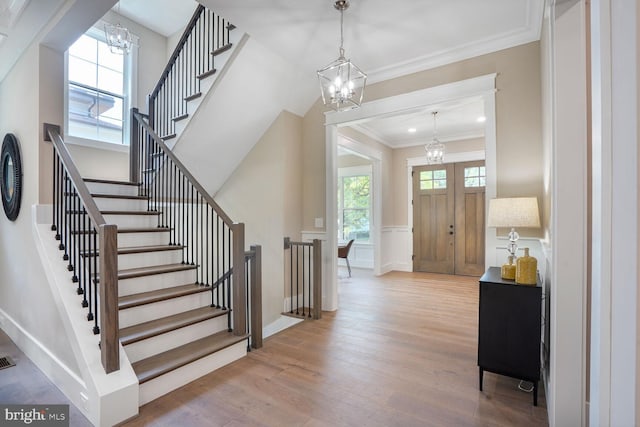 504 Kingsley Rd SW, Vienna, VA 22180 - foyer entrance with a chandelier, wood finished floors, plenty of natural light, stairway, and crown molding