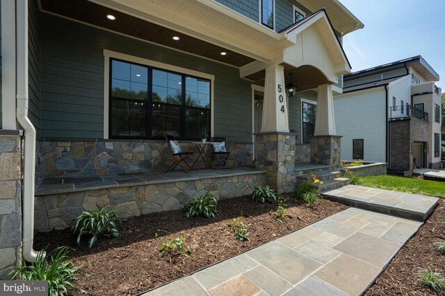 504 Kingsley Rd SW, Vienna, VA 22180 - view of exterior entry featuring covered porch and stone siding