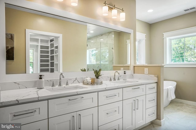 504 Kingsley Rd SW, Vienna, VA 22180 - full bathroom featuring marble finish floors, a stall shower, double vanity, a freestanding bath, and a spacious closet
