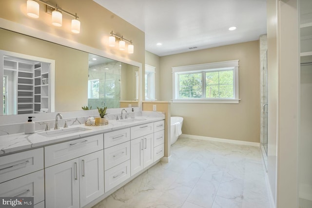 504 Kingsley Rd SW, Vienna, VA 22180 - bathroom with a shower stall, marble look tiles, double vanity, a spacious closet, and a soaking tub
