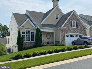 350 Quimby Dr, Wilmington, DE 19808 - craftsman house with stone siding, a chimney, a front lawn, and an attached garage