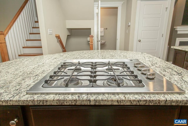 2105 Avinity Loop, Charlottesville, VA 22902 - kitchen with stainless steel gas stovetop, light stone counters, and dark brown cabinets