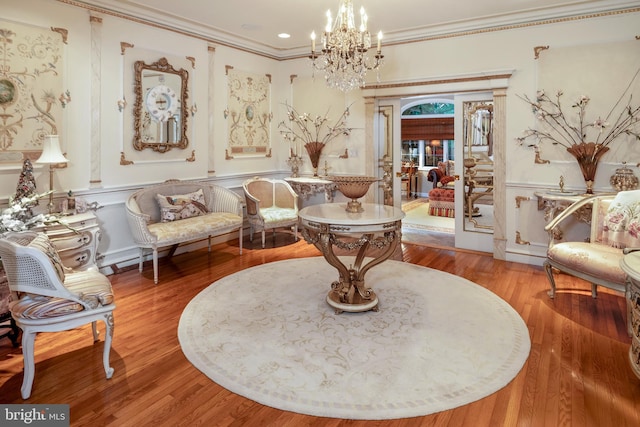 103 Marian Dr, Princeton Junction, NJ 08550 - sitting room with ornamental molding, a chandelier, a decorative wall, wood finished floors, and a wainscoted wall