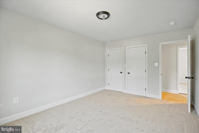 7016 Grace Landing Ct, Hughesville, MD 20637 - unfurnished bedroom with carpet, baseboards, and multiple closets