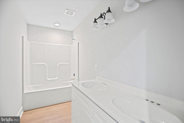 7016 Grace Landing Ct, Hughesville, MD 20637 - bathroom featuring wood finished floors, tub / shower combination, and double vanity