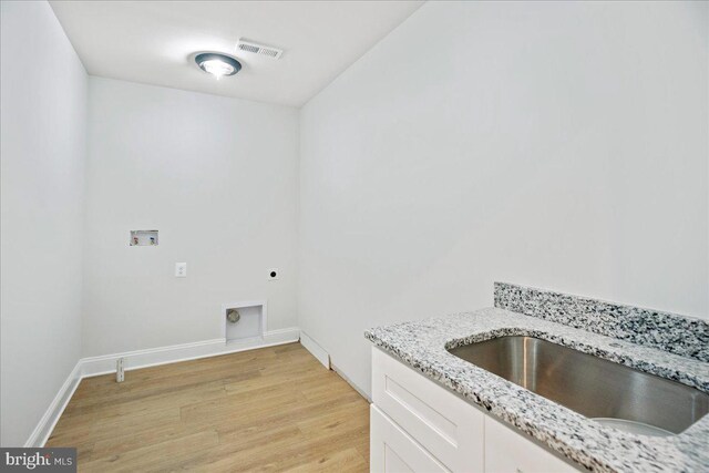 7016 Grace Landing Ct, Hughesville, MD 20637 - laundry area with electric dryer hookup, light wood-style floors, hookup for a washing machine, baseboards, and cabinet space