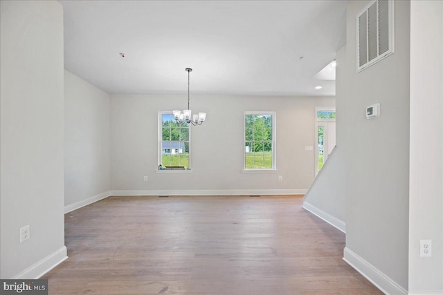 7016 Grace Landing Ct, Hughesville, MD 20637 - empty room featuring wood finished floors, a chandelier, baseboards, and recessed lighting