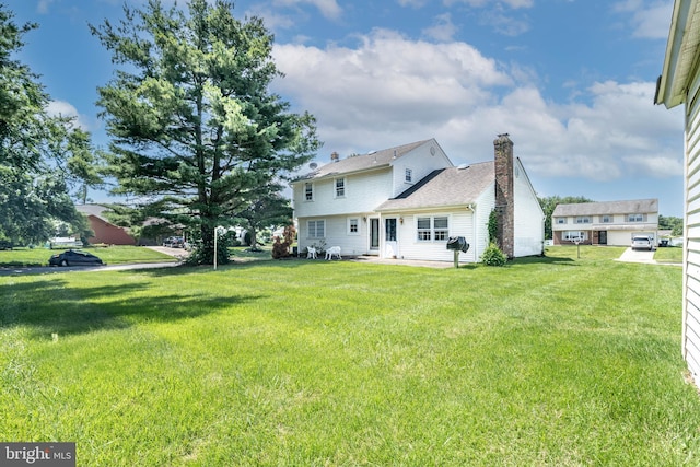 2301 Yellowstone Rd, Cinnaminson, NJ 08077 - back of property with a chimney and a lawn