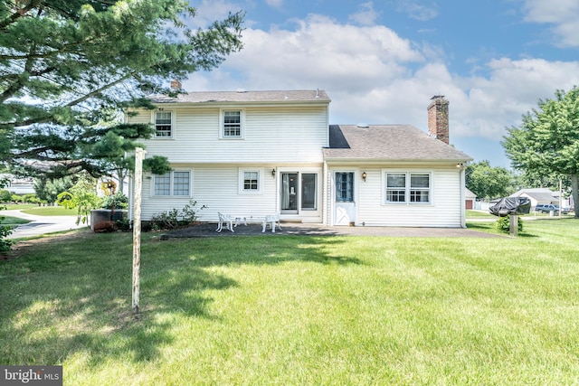 2301 Yellowstone Rd, Cinnaminson, NJ 08077 - back of house with a chimney, a lawn, and a patio