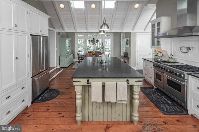 200 Hun Rd, Princeton, NJ 08540 - kitchen with premium appliances, wall chimney exhaust hood, dark countertops, dark wood-style floors, and white cabinets