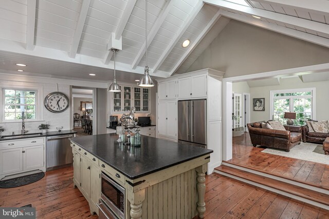 200 Hun Rd, Princeton, NJ 08540 - kitchen with appliances with stainless steel finishes, dark countertops, a sink, dark wood-type flooring, and beamed ceiling