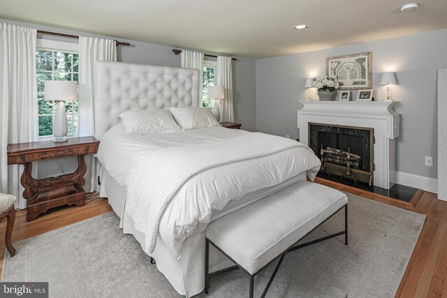 200 Hun Rd, Princeton, NJ 08540 - bedroom featuring a fireplace with flush hearth, wood finished floors, multiple windows, baseboards, and recessed lighting