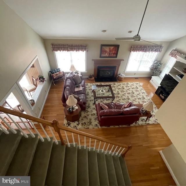 1359 Michael Way, Lansdale, PA 19446 - living area with a fireplace with flush hearth, plenty of natural light, a ceiling fan, and wood finished floors