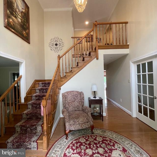 1359 Michael Way, Lansdale, PA 19446 - stairs with wood finished floors, a high ceiling, crown molding, baseboards, and a chandelier