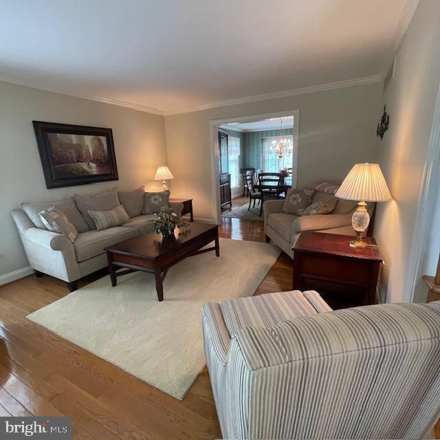 1359 Michael Way, Lansdale, PA 19446 - living area with wood finished floors, crown molding, a chandelier, and baseboards