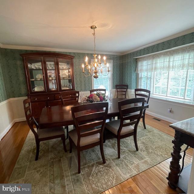 1359 Michael Way, Lansdale, PA 19446 - dining room featuring wallpapered walls, light wood-style flooring, a chandelier, crown molding, and a wainscoted wall
