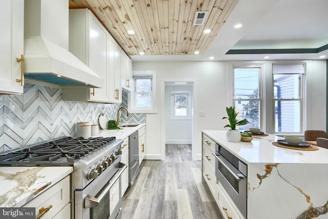 837 W 33rd St, Baltimore, MD 21211 - kitchen with appliances with stainless steel finishes, custom range hood, a sink, healthy amount of natural light, and recessed lighting