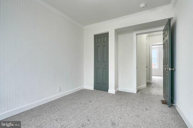 837 W 33rd St, Baltimore, MD 21211 - unfurnished bedroom with crown molding, carpet, baseboards, and a closet