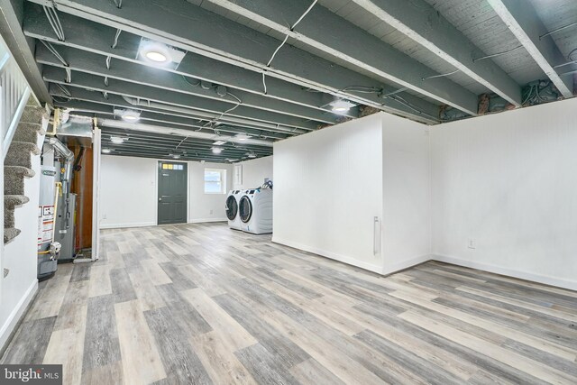 837 W 33rd St, Baltimore, MD 21211 - basement featuring washer and clothes dryer, wood finished floors, and baseboards