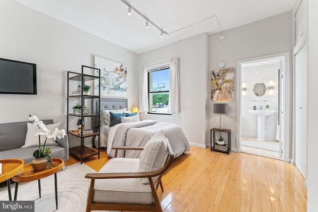 1822 15th St NW Unit 305, Washington, DC 20009 - bedroom with attic access, track lighting, light wood-style floors, and ensuite bathroom