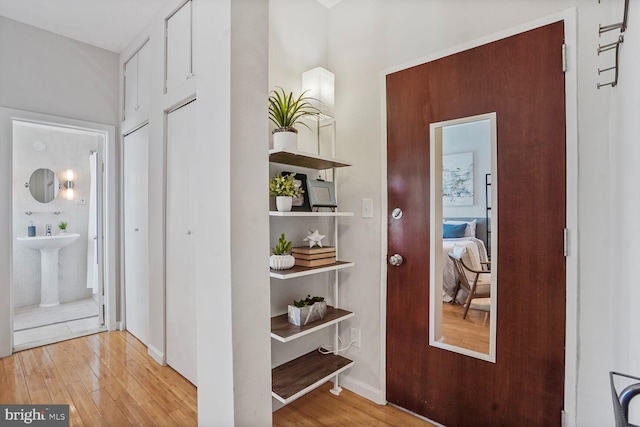 1822 15th St NW Unit 305, Washington, DC 20009 - hallway featuring light wood-type flooring and a sink