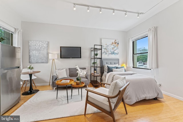 1822 15th St NW Unit 305, Washington, DC 20009 - bedroom featuring freestanding refrigerator, track lighting, and wood finished floors