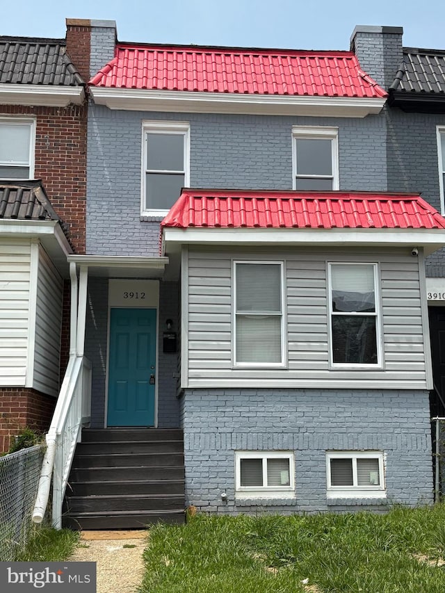 3912 W Garrison Ave, Baltimore, MD 21215 - view of property with brick siding, mansard roof, and a tiled roof
