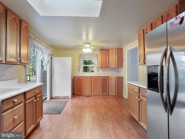 18540 Brooke Rd, Sandy Spring, MD 20860 - kitchen with stainless steel refrigerator with ice dispenser, freestanding refrigerator, plenty of natural light, and light wood-style flooring