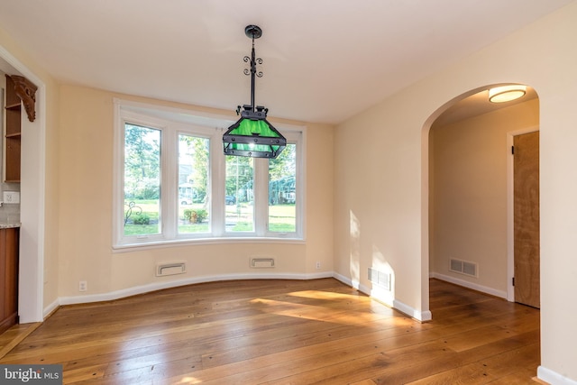 1901 Acorn Ln, Abington, PA 19001 - unfurnished dining area with arched walkways, light wood finished floors, and baseboards