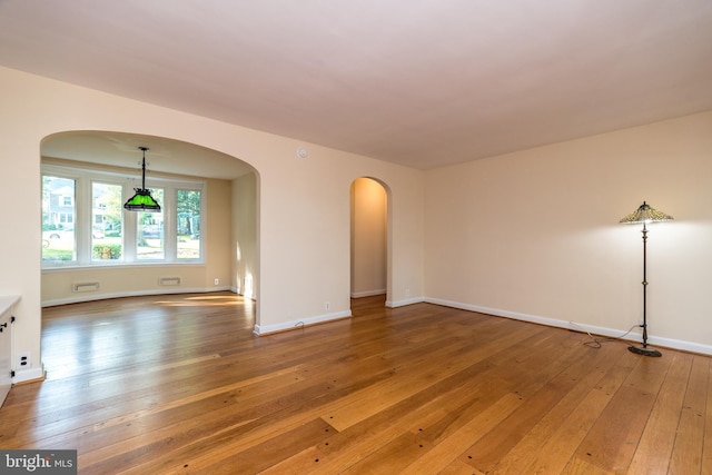 1901 Acorn Ln, Abington, PA 19001 - unfurnished room featuring arched walkways, light wood-style flooring, and baseboards