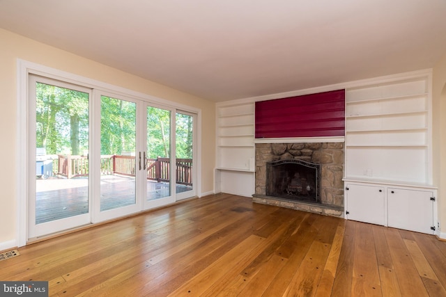 1901 Acorn Ln, Abington, PA 19001 - unfurnished living room featuring built in shelves, light wood-style flooring, and a fireplace