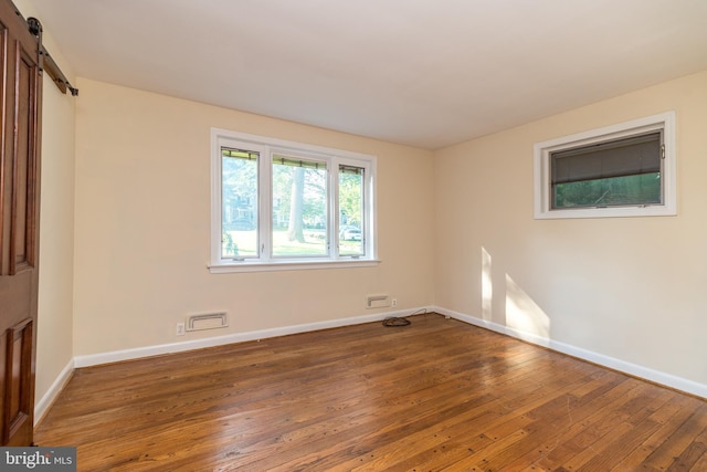 1901 Acorn Ln, Abington, PA 19001 - unfurnished room with wood-type flooring, baseboards, and a barn door