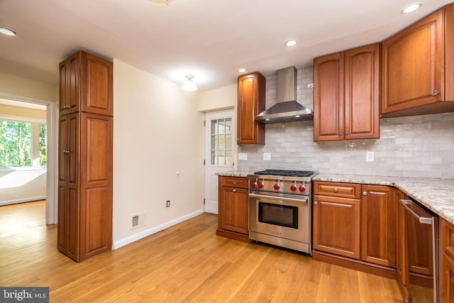 1901 Acorn Ln, Abington, PA 19001 - kitchen featuring stainless steel appliances, wall chimney exhaust hood, backsplash, light wood-style flooring, and recessed lighting