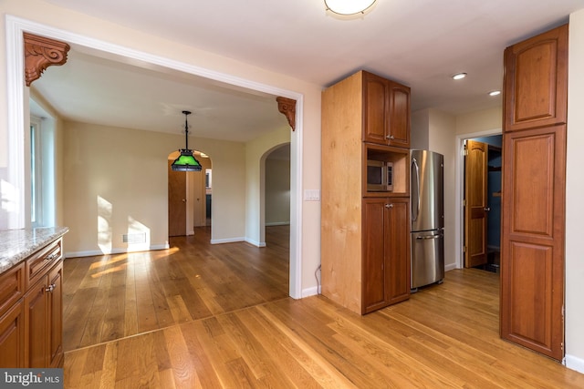 1901 Acorn Ln, Abington, PA 19001 - kitchen featuring stainless steel appliances, arched walkways, light wood finished floors, brown cabinetry, and recessed lighting