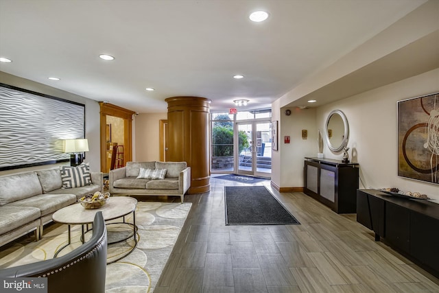 3900 Tunlaw Rd NW Unit 118, Washington, DC 20007 - living room with recessed lighting, a wall of windows, wood finished floors, and baseboards