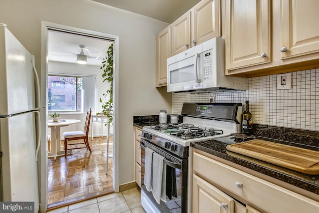 3900 Tunlaw Rd NW Unit 118, Washington, DC 20007 - kitchen featuring white appliances, backsplash, baseboards, light brown cabinets, and dark stone counters