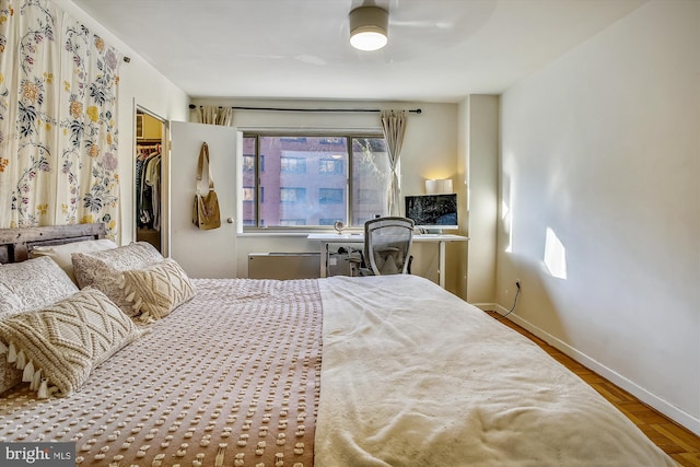 3900 Tunlaw Rd NW Unit 118, Washington, DC 20007 - bedroom featuring baseboards, a spacious closet, a closet, wood finished floors, and a desk