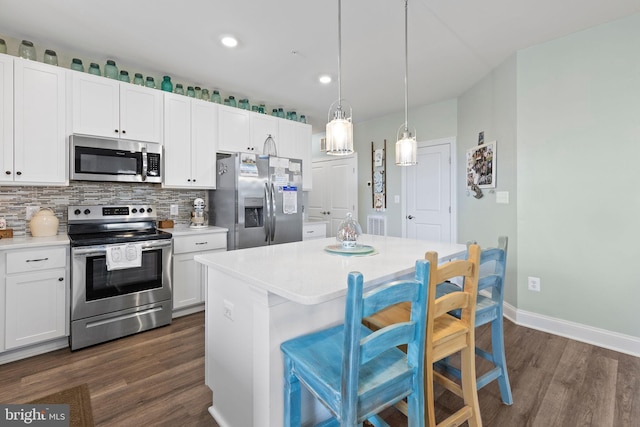 401 Bold Ruler Ct Unit 302, Havre De Grace, MD 21078 - kitchen featuring appliances with stainless steel finishes, dark wood-style flooring, baseboards, light countertops, and a breakfast bar area