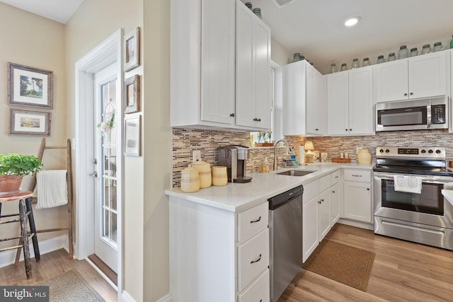 401 Bold Ruler Ct Unit 302, Havre De Grace, MD 21078 - kitchen with appliances with stainless steel finishes, a sink, light wood-style flooring, tasteful backsplash, and recessed lighting