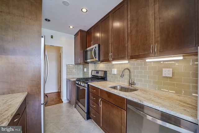 2475 Virginia Ave NW Unit 930, Washington, DC 20037 - kitchen with stainless steel appliances, light stone counters, tasteful backsplash, recessed lighting, and light tile patterned floors
