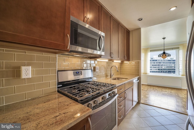 2475 Virginia Ave NW Unit 930, Washington, DC 20037 - kitchen featuring appliances with stainless steel finishes, light stone counters, light tile patterned floors, backsplash, and recessed lighting