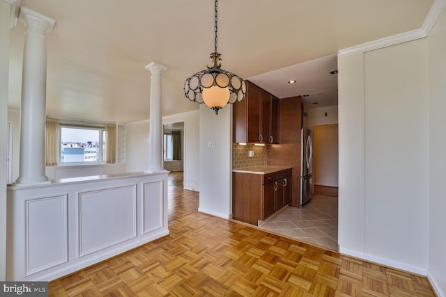 2475 Virginia Ave NW Unit 930, Washington, DC 20037 - kitchen with ornate columns, freestanding refrigerator, backsplash, light countertops, and recessed lighting