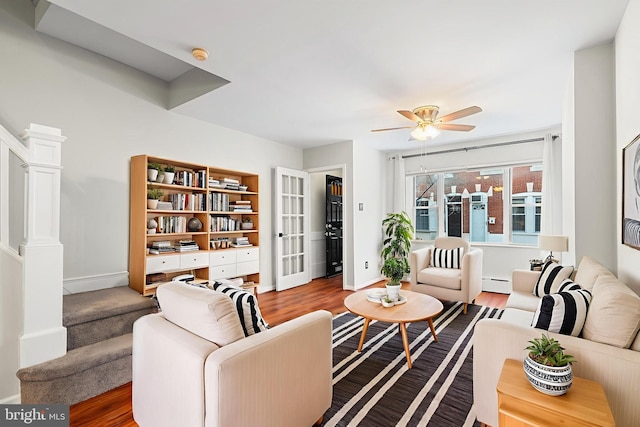 1238 Durfor St, Philadelphia, PA 19148 - living room featuring ceiling fan, a baseboard radiator, stairway, and wood finished floors