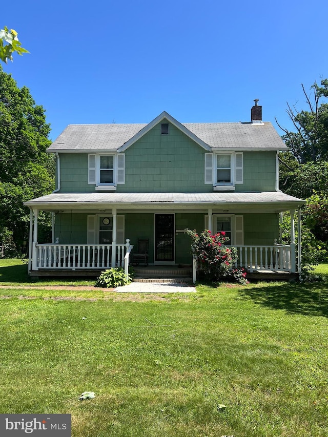 10530 Scaggsville Rd, Laurel, MD 20723 - farmhouse featuring covered porch, a chimney, and a front yard