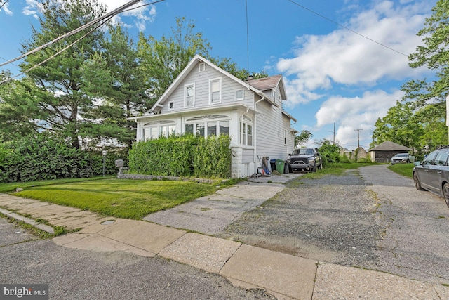 3006 Glenmore Ave, Baltimore, MD 21214 - view of front of house featuring driveway and a front lawn