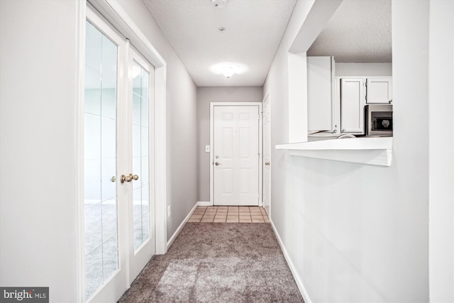 12009 Taliesin Pl Unit 36, Reston, VA 20190 - doorway to outside with light carpet, baseboards, and a textured ceiling