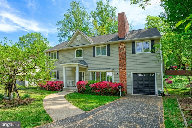 3820 Lorcom Ln, Arlington, VA 22207 - view of front of home featuring an attached garage, a chimney, driveway, and a front yard
