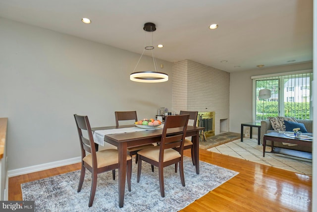 3820 Lorcom Ln, Arlington, VA 22207 - dining room featuring recessed lighting, light wood-style flooring, baseboards, and a fireplace