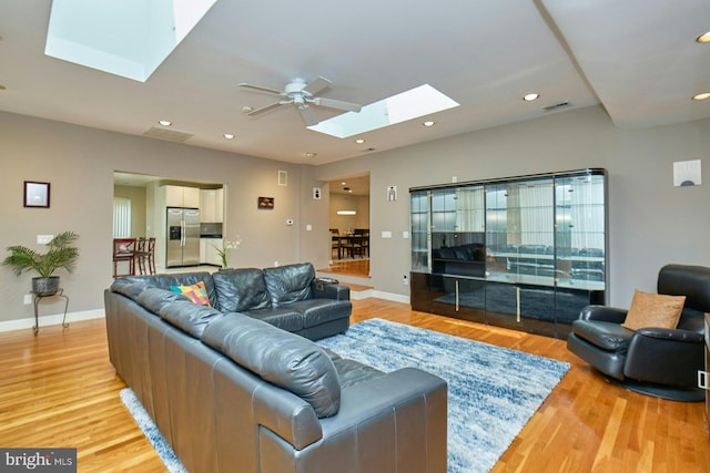 3820 Lorcom Ln, Arlington, VA 22207 - living area with a skylight, a ceiling fan, light wood-style flooring, and recessed lighting