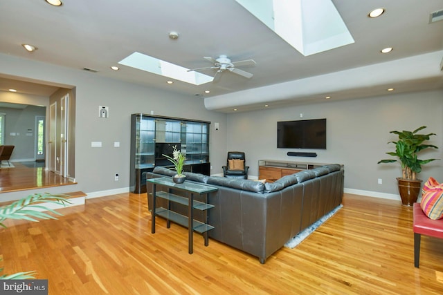 3820 Lorcom Ln, Arlington, VA 22207 - living room featuring a skylight, light wood-style flooring, baseboards, and recessed lighting